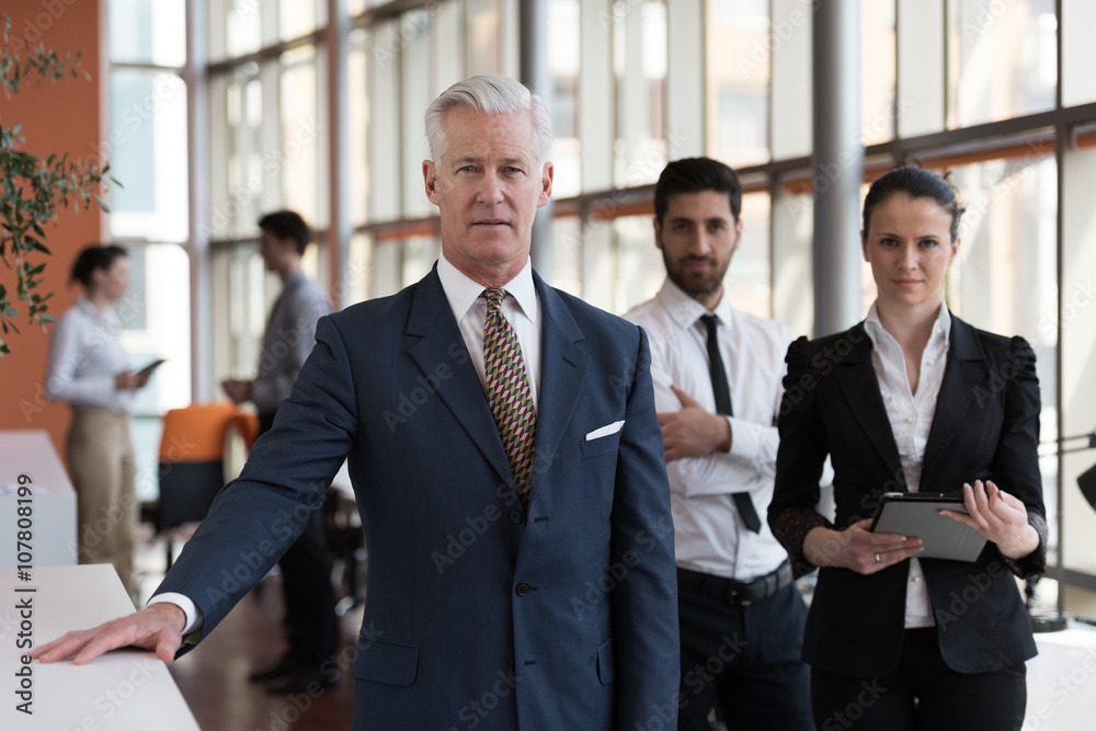 portrait of senior businessman as leader with group of people i portrait of senior businessman as leader with group of people i