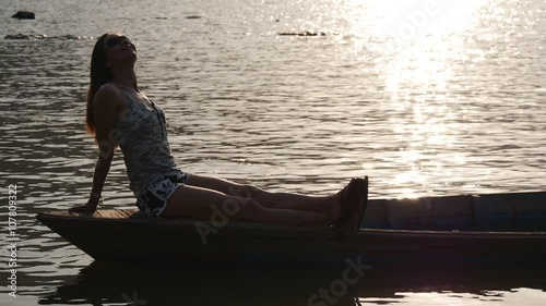 Woman in the boat takes solar shower
