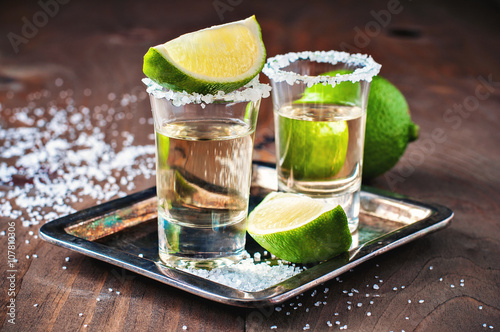 Tequila gold, Mexican, alcohol in shot glasses, lime and salt, toned image, selective focus photo