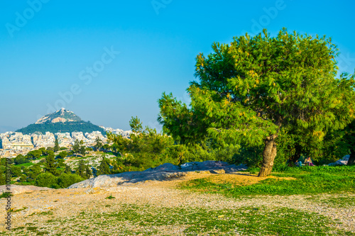 people are having a picnic on philipoppou hill with view on lycabetus hill in athnes photo