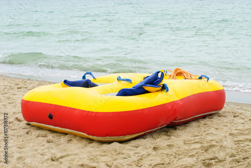 red yellow air mattress at a beautiful beach with a sea