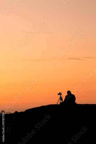 Silhouette of a young photographer during the sunset,sunrise