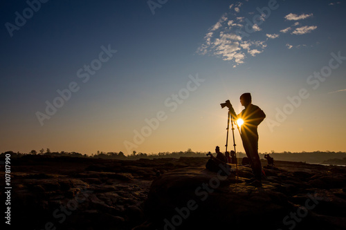 Silhouette of a young photographer during the sunset,sunrise