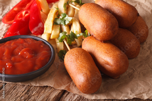 American fast food: Corn dogs, french fries and ketchup close-up. horizontal
