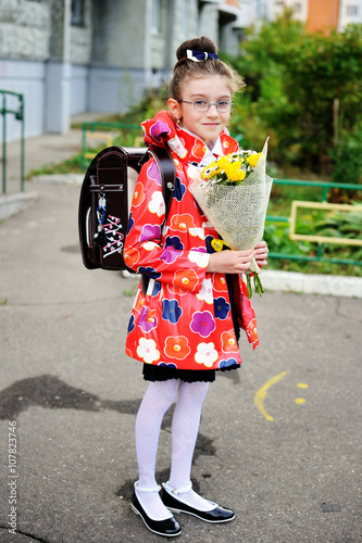 Kid girl in jacket on her way to school