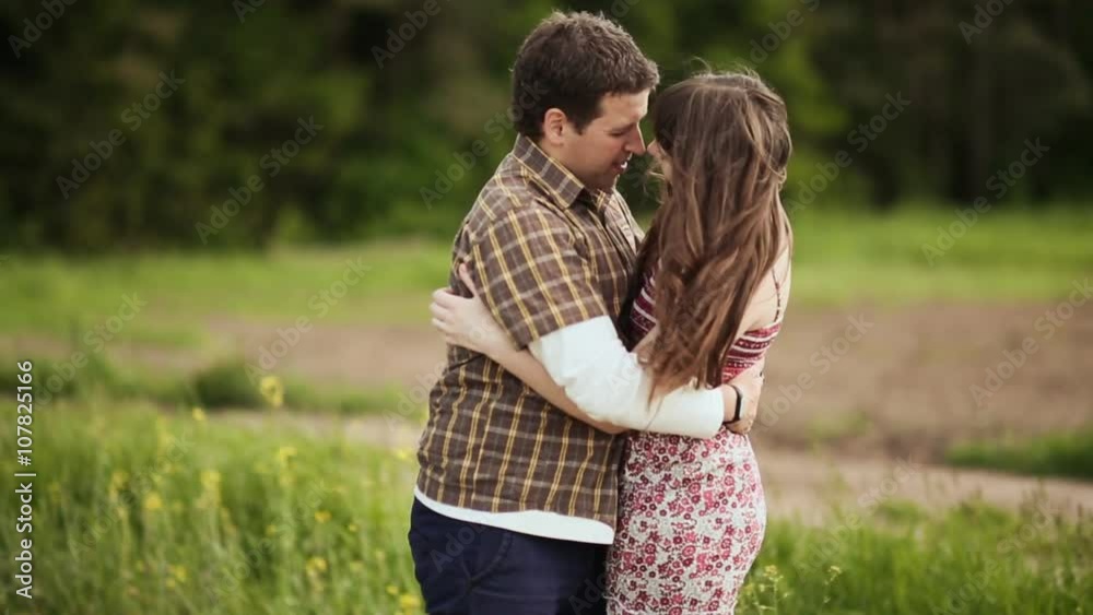 Loving couple embracing on a field Loving couple embracing on a field