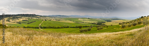 Tuscany wheat field hill panorama before a storm