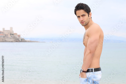 handsome man posing next to the sea