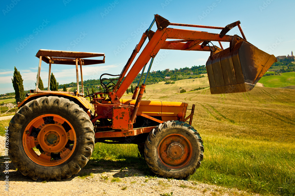 Red bulldozer in a what field in a sunny day Red bulldozer in a what field in a sunny day