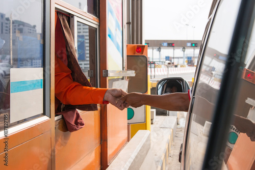 Hand paying express toll way on the raod.