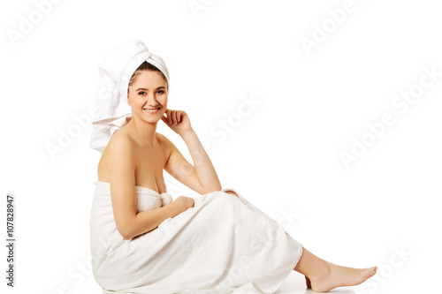 Young smile woman wrapped towels sitting 