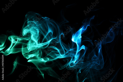 Colored abstract smoke, isolated on black background. © foxyxof