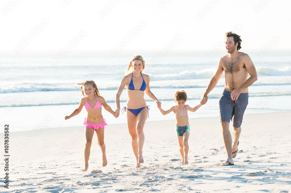 Family running at beach