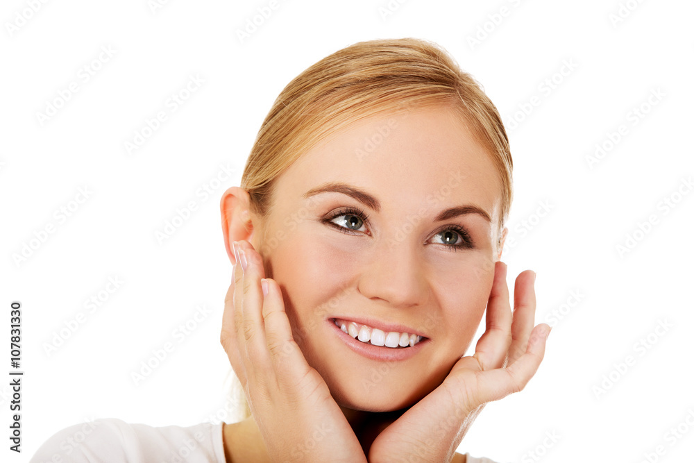 Young happy woman holding both hands on cheeks