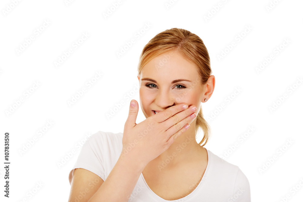 Young woman giggles covering her mouth with hand Young woman giggles covering her mouth with hand