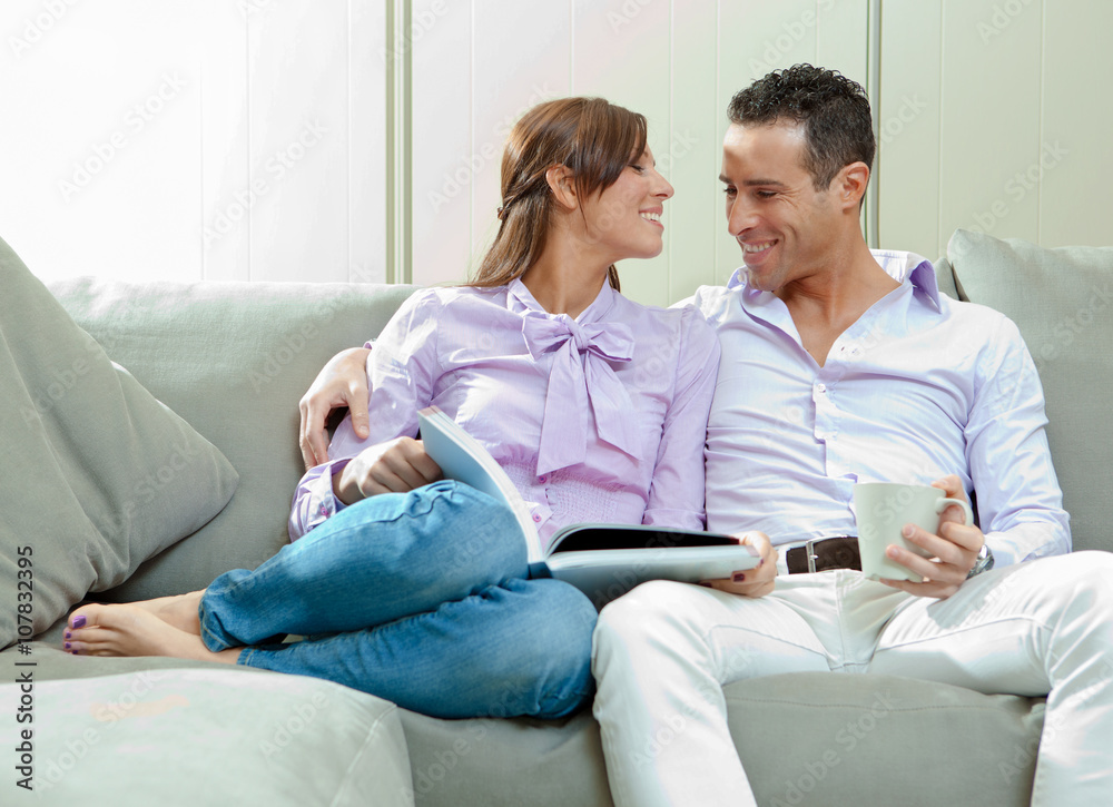 young happy couple relax on couch at home young happy couple relax on couch at home