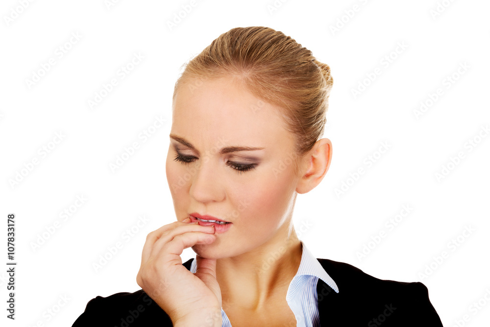 Young nervous business woman biting her nails Young nervous business woman biting her nails
