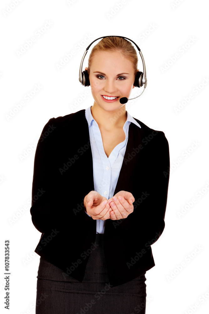 Young business woman in headset holding copyspace or something Young business woman in headset holding copyspace or something