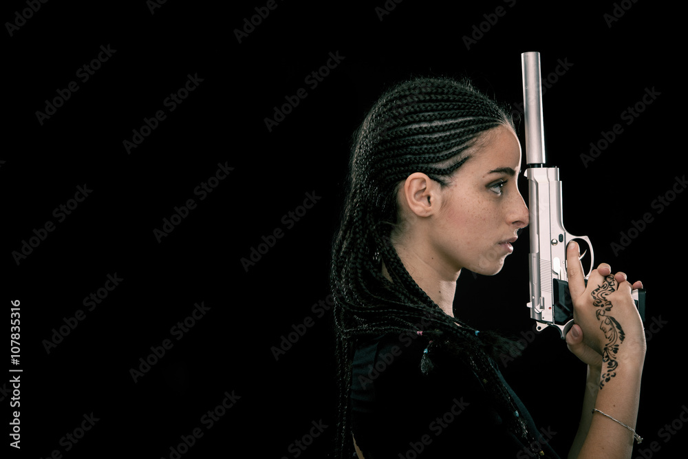 Beautiful dread young woman with gun portrait isolated on black Beautiful dread young woman with gun portrait isolated on black