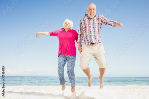 Happy senior couple jumping 