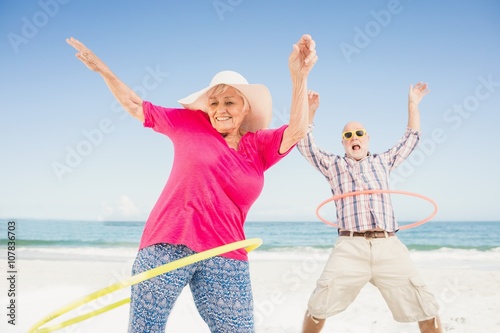 Senior couple doing hula hoop photo