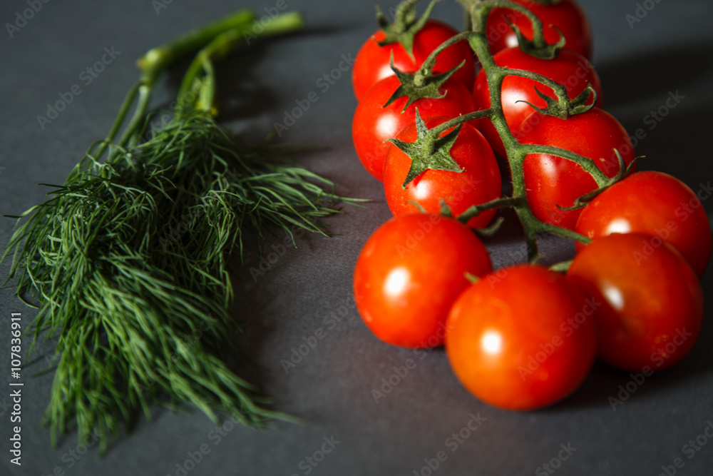 Tomatoes with green pappers and herbs on gray Tomatoes with green pappers and herbs on gray