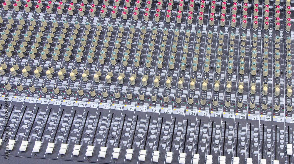 background of knobs and control buttons of a music mixer panel