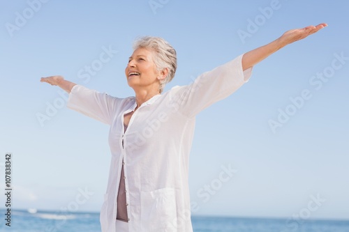 Casual senior woman with arms outstretched