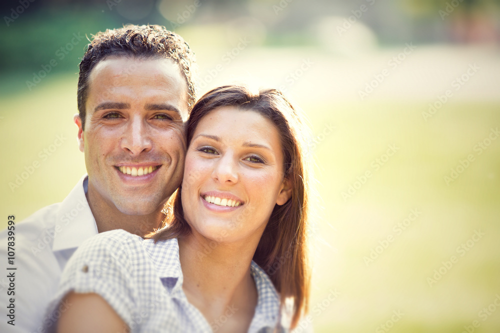 young brunette couple having fun together at the park