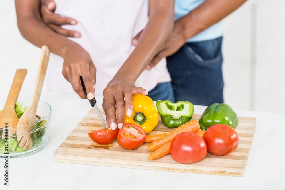 Woman cutting vegetables on chopping board Woman cutting vegetables on chopping board