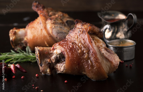 Roasted pork knuckle with mustard, spices and rosemary