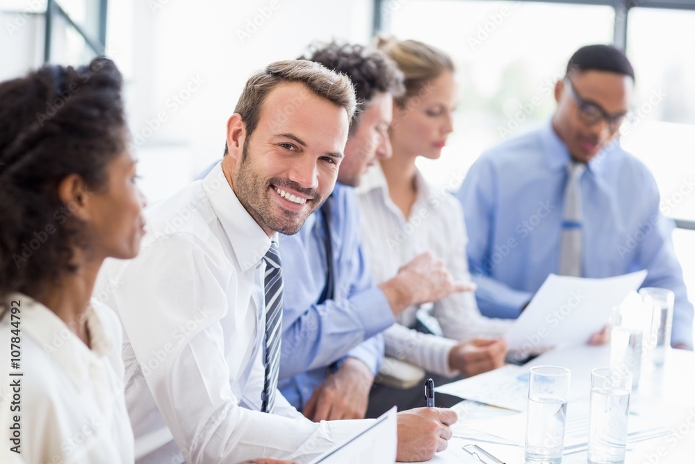 Portrait of businessman writing a report