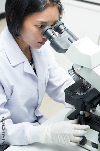 woman working in a laboratory with microscope