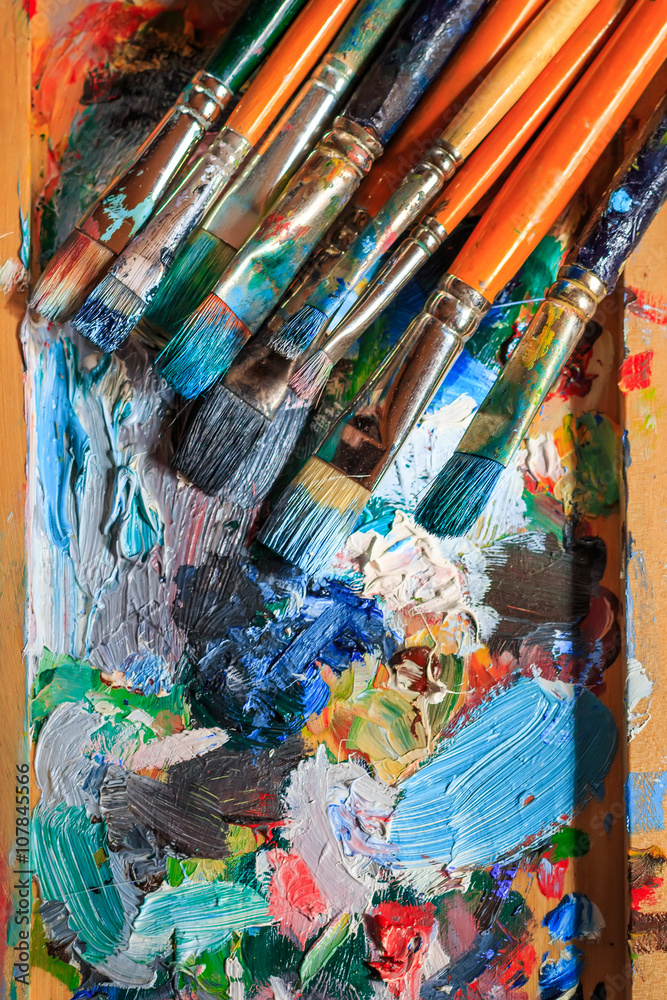 Fototapeta Colourful oil paint, different types of brushes and palette