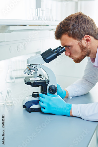 Chemist with microscope