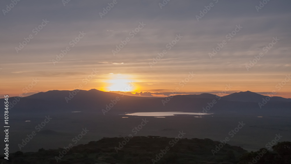 Panoramic view of huge Ngorongoro caldera (extinct volcano crater) with setting Sun against evening glow background at dusk. Great Rift Valley, Tanzania, East Africa.
Panoramic view of huge Ngorongoro caldera (extinct volcano crater) with setting Sun against evening glow background at dusk. Great Rift Valley, Tanzania, East Africa.