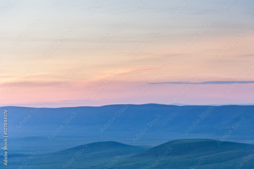 Panoramic view of huge Ngorongoro caldera (extinct volcano crater) against evening glow background at dusk. Great Rift Valley, Tanzania, East Africa.