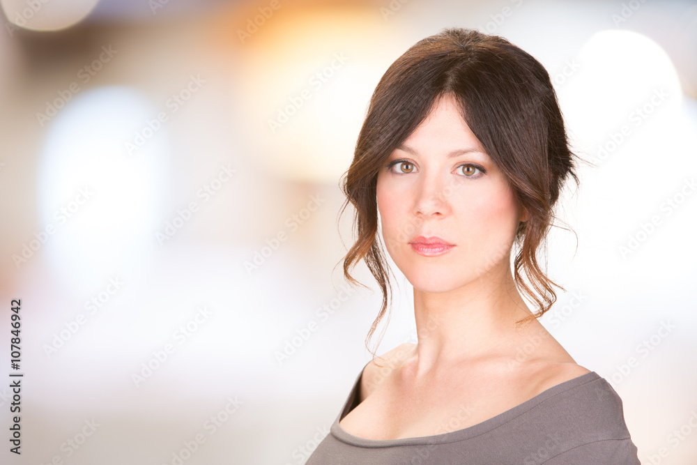 serious brunette woman isolated on bright background