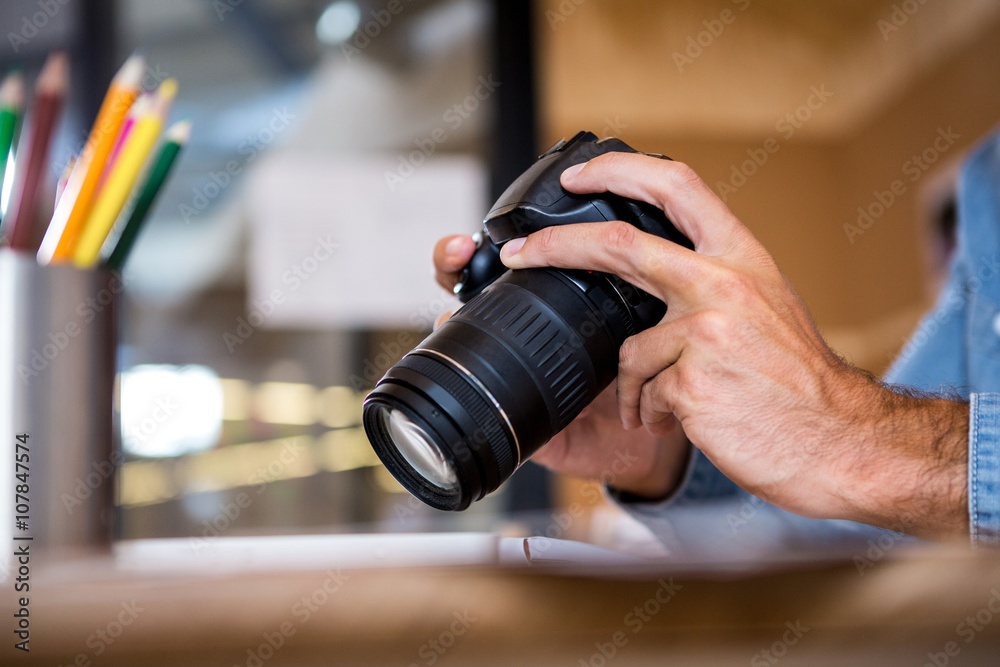 Man checking photos in camera Man checking photos in camera