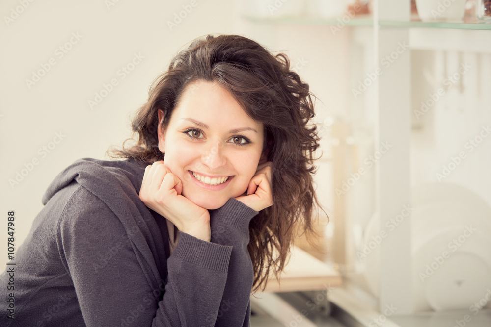young smiling brunette woman in the kitchen young smiling brunette woman in the kitchen