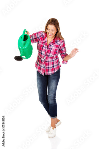 Happy woman holding a watering can