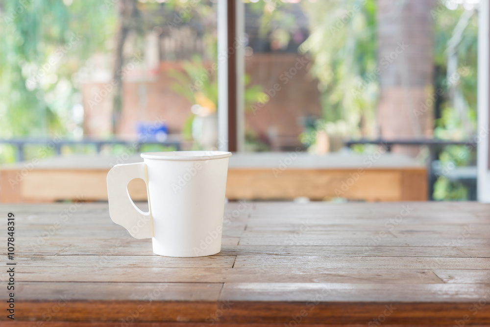 Coffee cup on wood table in cafe