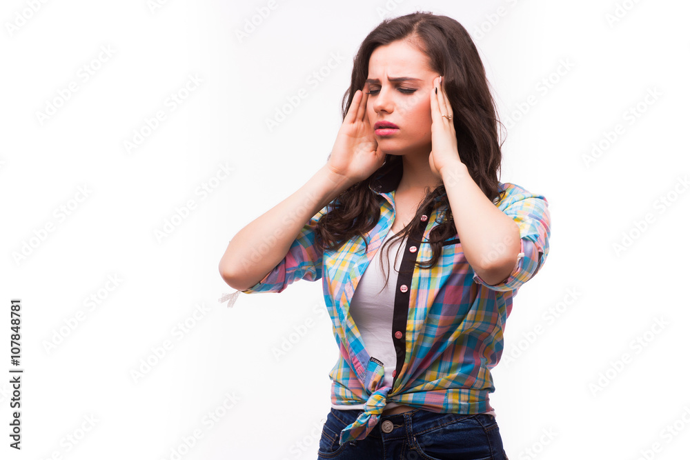 Head pain. Girl holding head in hands and keeping eyes closed while standing against white background Head pain. Girl holding head in hands and keeping eyes closed while standing against white background