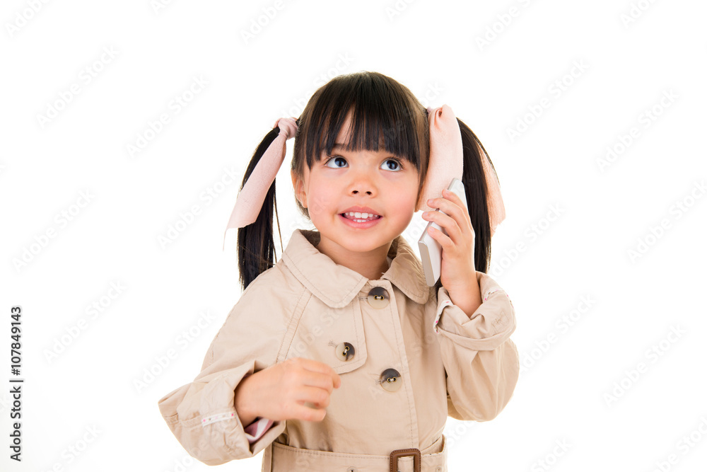 asian smiling little girl talking on the phone isolated on white asian smiling little girl talking on the phone isolated on white