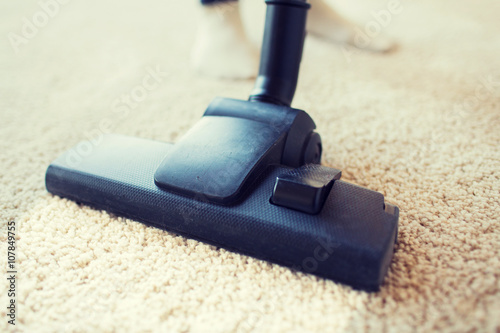 close up of vacuum cleaner cleaning carpet at home
