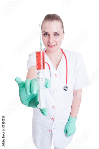 Young female doctor or nurse showing syringe in close-up