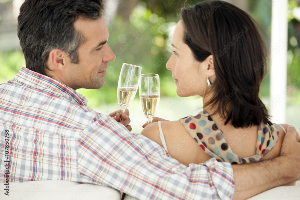 Middle-aged couple drinking Champagne Middle-aged couple drinking Champagne