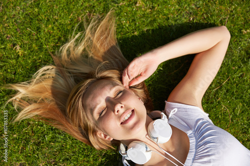 Woman laying in summer in grass