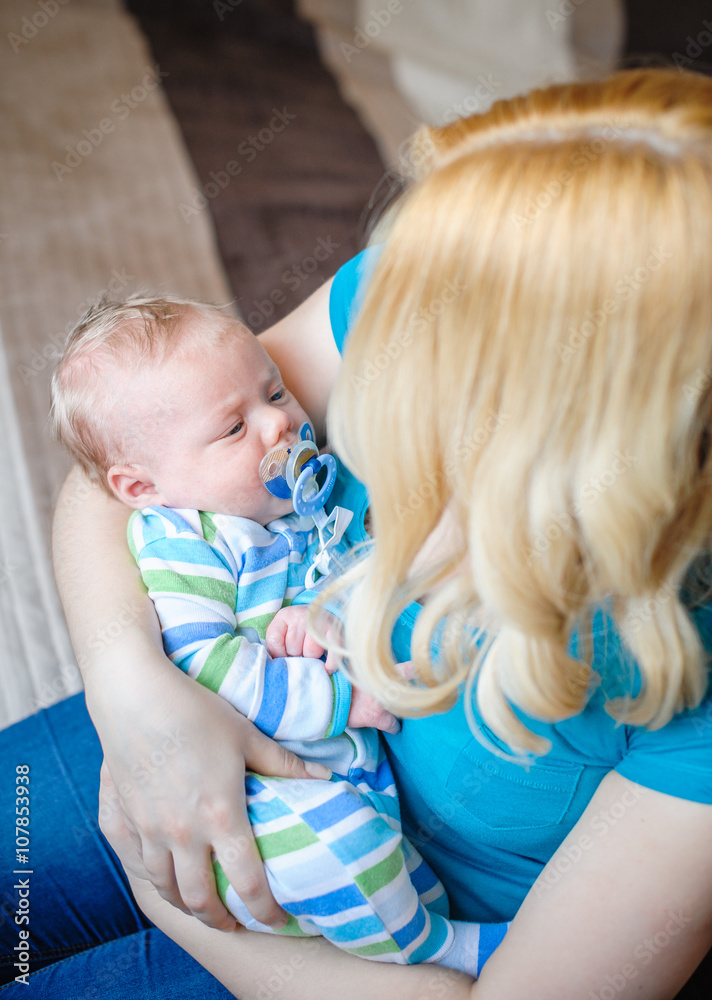 Mother keeps a little baby boy in her arms Mother keeps a little baby boy in her arms