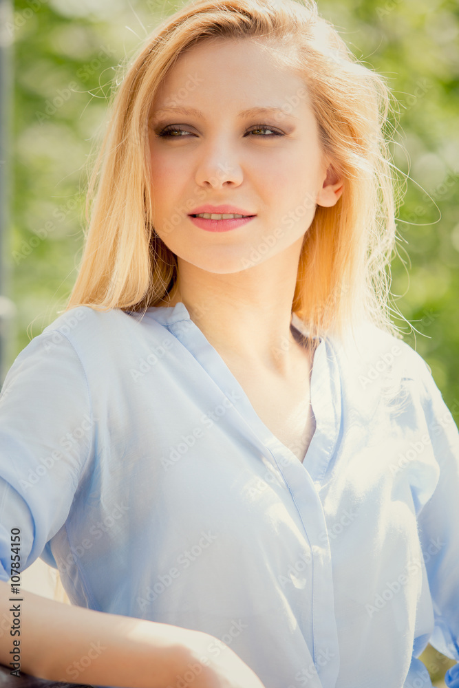 smiling blonde young woman relax in a garden smiling blonde young woman relax in a garden